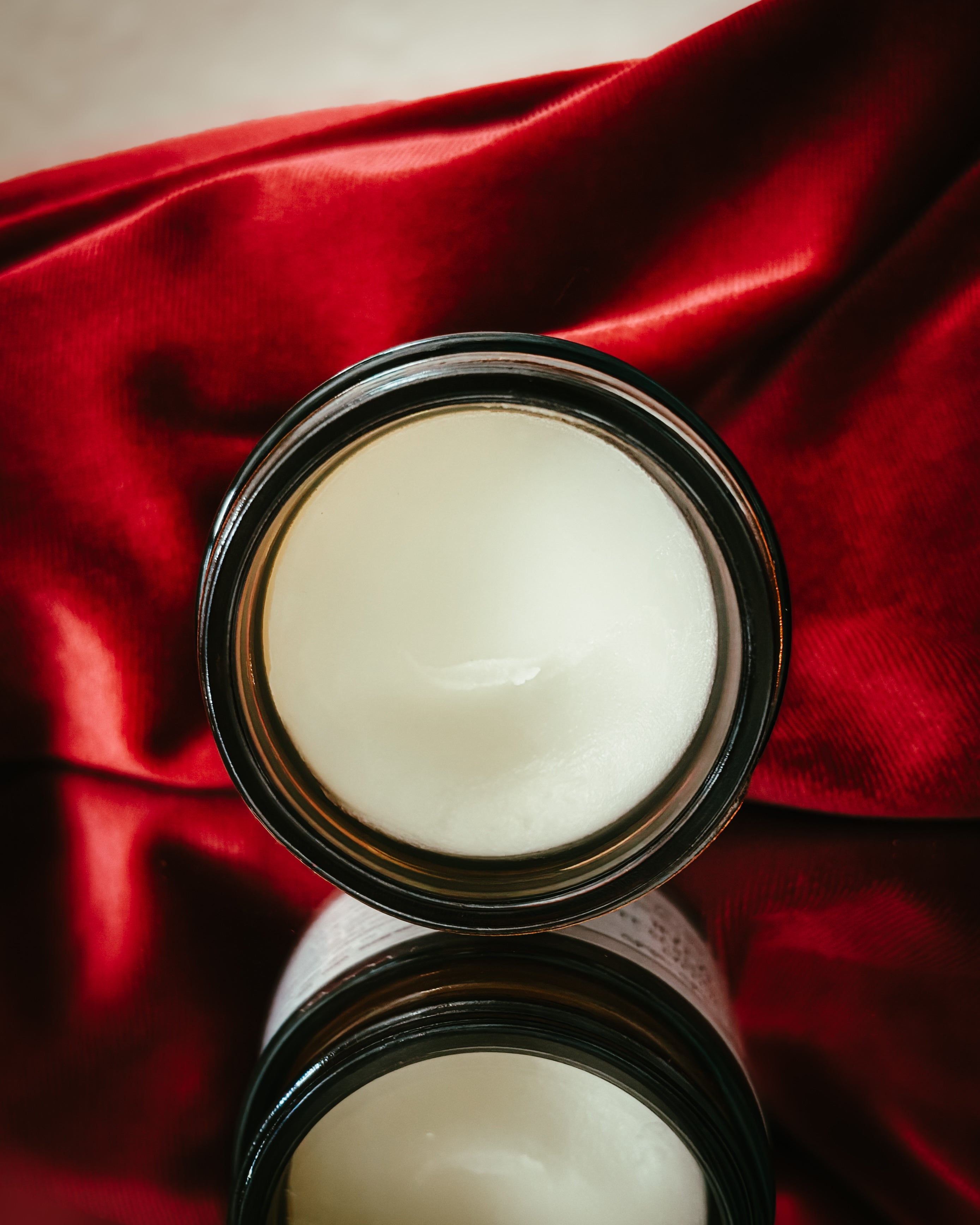 white all-purpose balm in a dark jar 